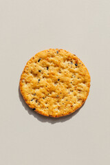 single round multigrain cracker isolated on white with shadow