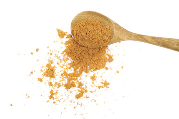 Pile brown unrefined sugar in wooden spoon, muscovado isolated on white, top view