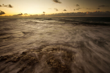Ocean wave being sucked back out at dusk