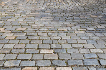 Full frame abstract texture background of a European cobblestone courtyard surface with gray stones