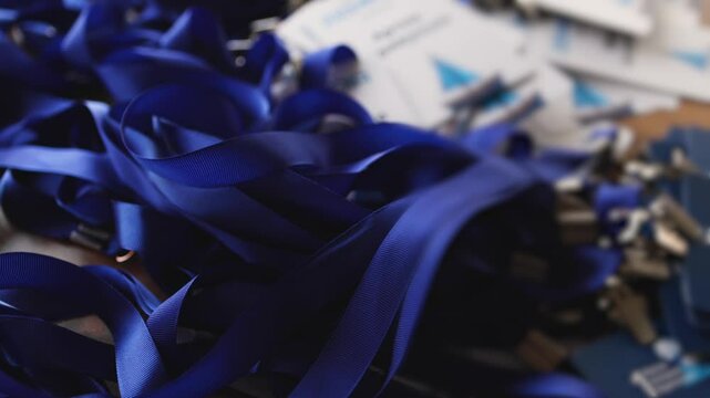 Process of checking in on conference congress forum event, registration desk table, visitors and attendees receiving lanyard with name badge and entry wristband bracelet and register electronic ticket