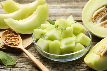 Slices of yummy melon on wooden table, closeup