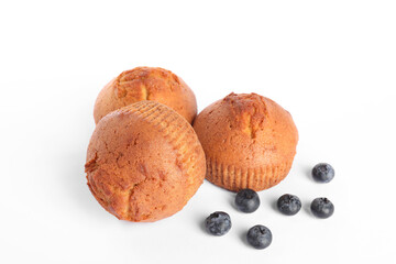 Delicious sweet muffins and blueberries isolated on white