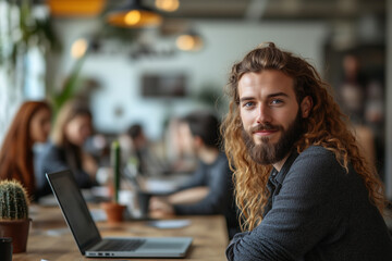 Obraz premium A group of colleagues working on laptops in a collaborative workspace surrounded by modern decor