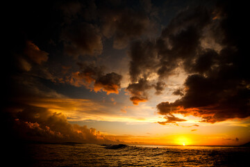 Majestic sunset reflecting off parting storm clouds and beautiful ocean 