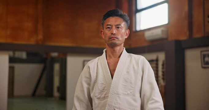 Face, Asian man or bow in dojo for respect, karate practice etiquette or self defense in class. Portrait, honor or student in Japan for learning martial arts, combat training or workout for fighting
