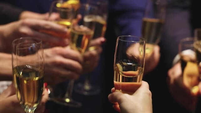 Group of businessmen celebrate, closing successful concluded deal, guests clinking raise glasses with alcohol, sparkling wine, toasting and cheering, colleagues team in office on corporate party event
