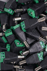 A lot of male DC power plug connectors for CCTV security cameras security concept. selective focus