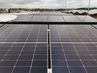 Industrial Roof Covered with Numerous Solar Panels Installed on Metal Frames