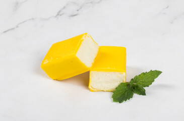 Cottage cheese candy bar in lemon chocolate glaze. Close up. White background	