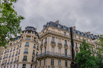 Fototapeta premium Streets of Paris, France. Windows of buildings and cars over the road.