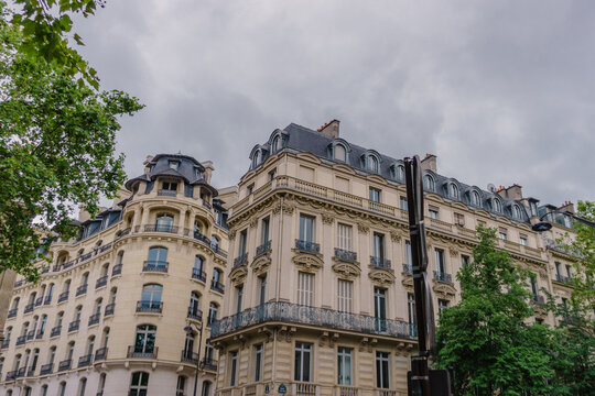 Streets of Paris, France. Windows of buildings and cars over the road.
