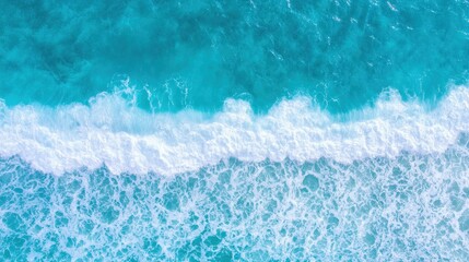 Obraz premium Experience the breathtaking clash of ocean waves and rocky shore, revealing stunning turquoise depths and white foam patterns.