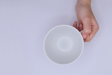Hand with empty cup. Above angle.