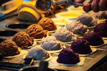 a vendor in the process of making hot and steaming wheel cakes