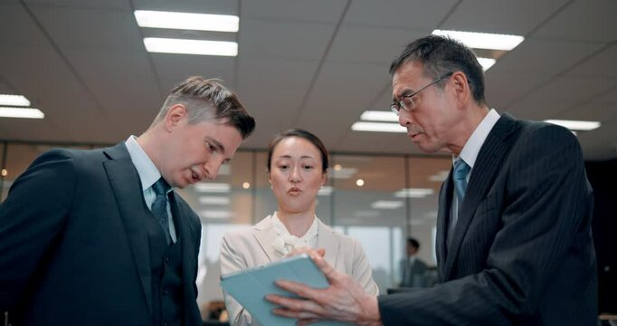 Tablet, group and business people planning, discussion or training in office meeting in Japan. Technology, team and collaboration with project manager for solution, problem solving or coaching intern