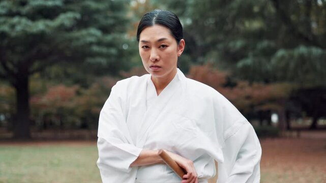 Martial arts, warrior and face of woman, outdoor and serious for training, fighter and confident. Tradition, kenjutsu and keikogi for culture, Japanese person and discipline for performance in Japan