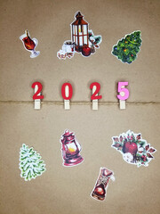 Christmas background brown paper new year 2025 numbers on decorative clothespins, xmas tree, mulled wine
