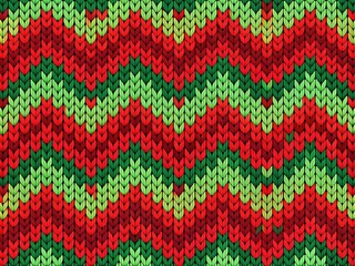 Knitted background with a bold red and green geometric design.