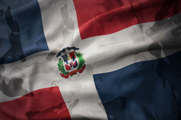 colourful waving flag of dominican republic on the old army khaki texture background. military...
