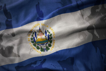 colourful waving flag of el salvador on the old army khaki texture background. military concept.