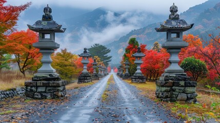 Obraz premium A serene pathway lined with stone lanterns and vibrant autumn foliage.