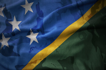 colourful waving flag of Solomon Islands on the old army khaki texture background. military concept.