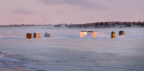 Ice fishing along the frozen shores of Prince Edward Island, Canada.
