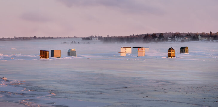 Ice fishing along the frozen shores of Prince Edward Island, Canada.