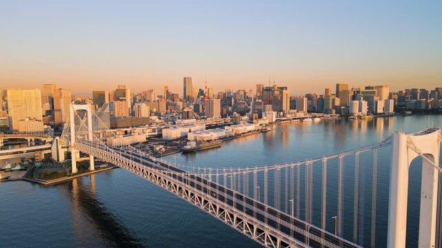 tokyo city bay modern skyline aerial view drone of rainbow bridge with high-rise business buildings in the background at sunrise dawn