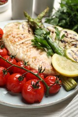Delicious grilled vegetables and chicken breast on table, closeup