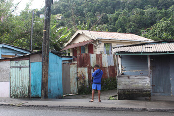 Boy in front of houses looking down in Castries, Saint Lucia