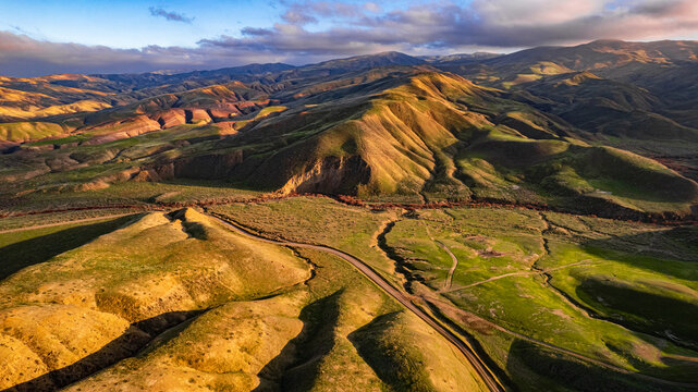Rural winding road through ancient rolling hills
