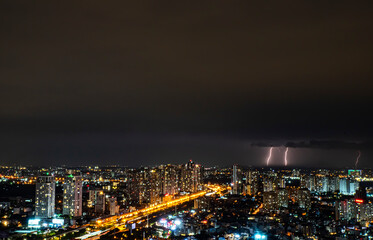 Fototapeta premium A city at night with a storm in the sky