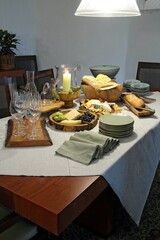 sophisticated table setting with breads, cheeses and assorted fruits