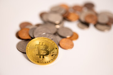 Coins and Bitcoin crypto on a white table