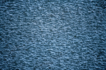 Rain. Raining time. Falling raindrops. Water background. Water surface. Water surface background. Raindrops background. Water drop splash. Raining outside.