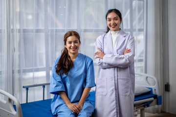 Fototapeta premium Two women in hospital uniforms are smiling for the camera