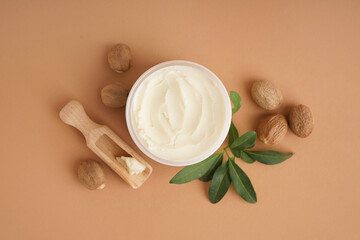 Jar with shea butter on beige background