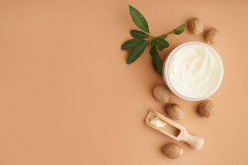 Jar with shea butter on beige background