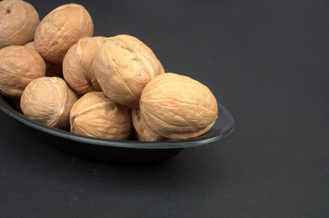 Walnut in black bowl with black background