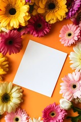 Obraz premium A blank white card on an orange background, surrounded by colorful flowers