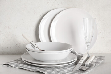Set of light stylish tableware on white background