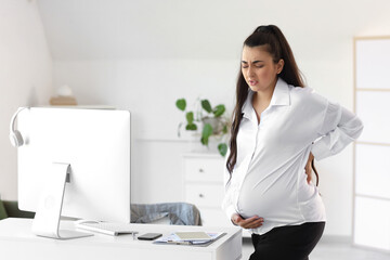 Pregnant businesswoman feeling bad in office