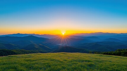 Obraz premium A beautiful mountain landscape with a bright orange sun in the sky