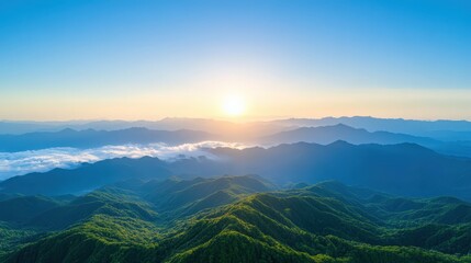 Fototapeta premium The sun is setting over the mountains, casting a warm glow over the landscape
