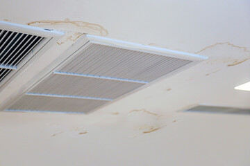 Water drop leak on air conditioner grille is ceiling stain and cracked and mold.