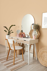 Interior of dressing room with makeup table, mirror and plants