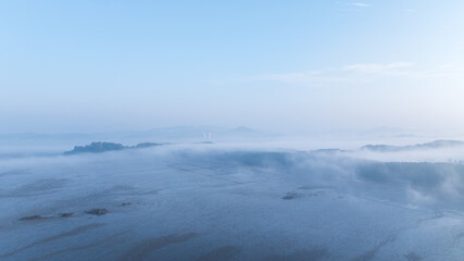 Obraz premium Aerial View Foggy Forest sunshine pine tree fog beach 