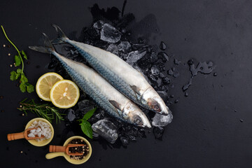 Raw Mackerel with Rosemary Lemon, basil and salt Healthy fresh seafood Placed on a black background. Top view with space for text.